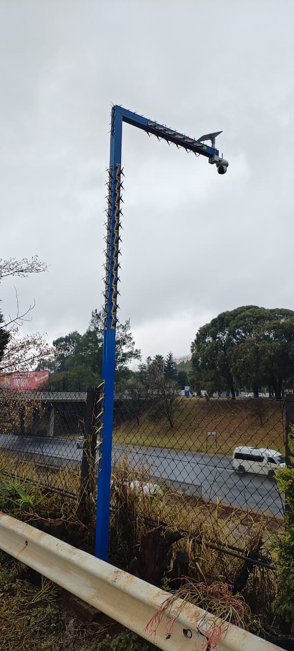 A Safer City camera on a blue pole overlooking a Bedfordview highway bridge